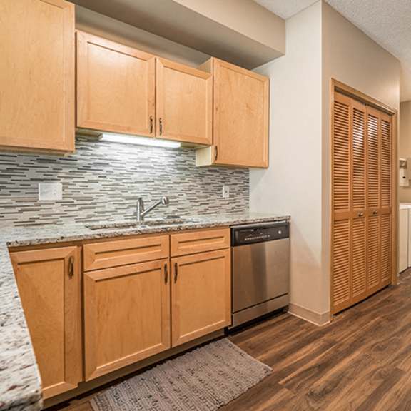 Thumbnail 6 of 21 Upgraded unit with stainless-steel appliances and kitchen backsplash at Southwind Villas in La Vista, NE