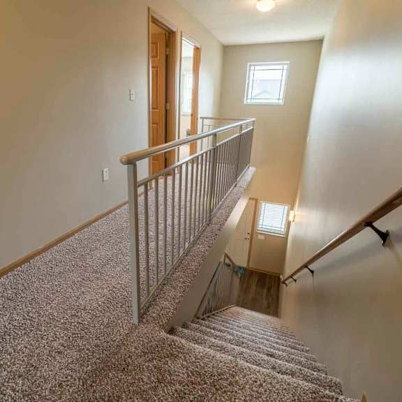 Thumbnail 9 of 21 Stairwell to upstairs in a two-bedroom townhome at Southwind Villas in southwest Omaha in La Vista, NE, 68128