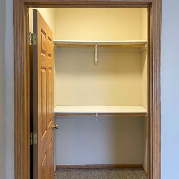 Thumbnail 16 of 18 a walk-in closet with two built-in shelves and hanging space