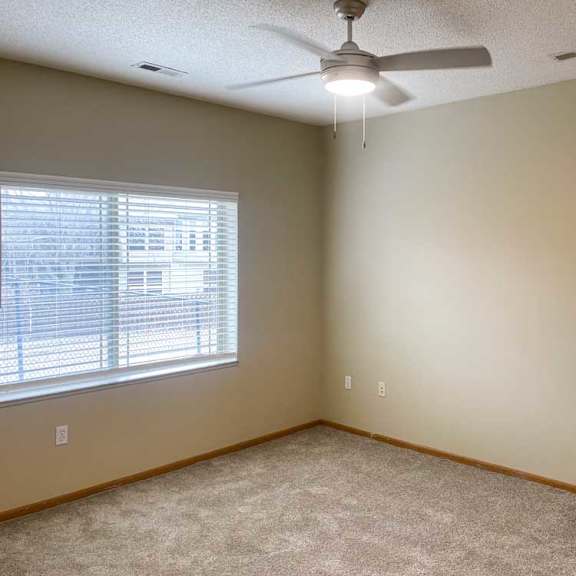 Thumbnail 15 of 18 a bedroom with a ceiling fan and a window with blinds