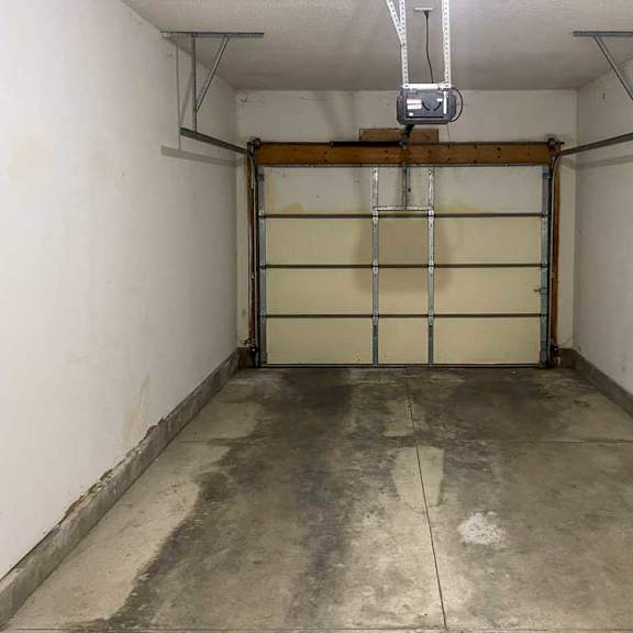 Thumbnail 18 of 18 a garage with a close white garage door