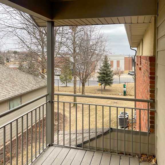 Thumbnail 5 of 21 a balcony with a metal railing and a brown awning
