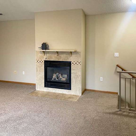 Thumbnail 10 of 21 a living room with a fireplace and a mantle