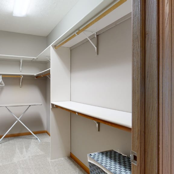 Thumbnail 17 of 19 a walk in closet with ample hanging and shelving space