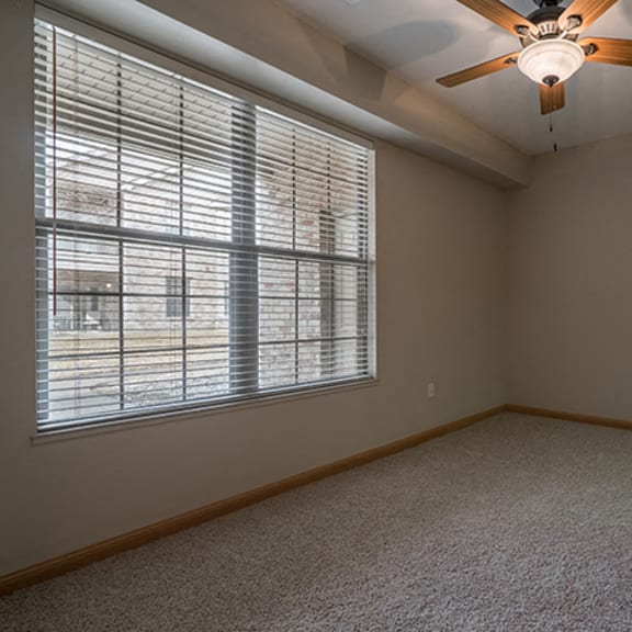 Thumbnail 6 of 9 Large bedroom with ceiling fan at Stone Creek Villas Apartments in Omaha Nebraska