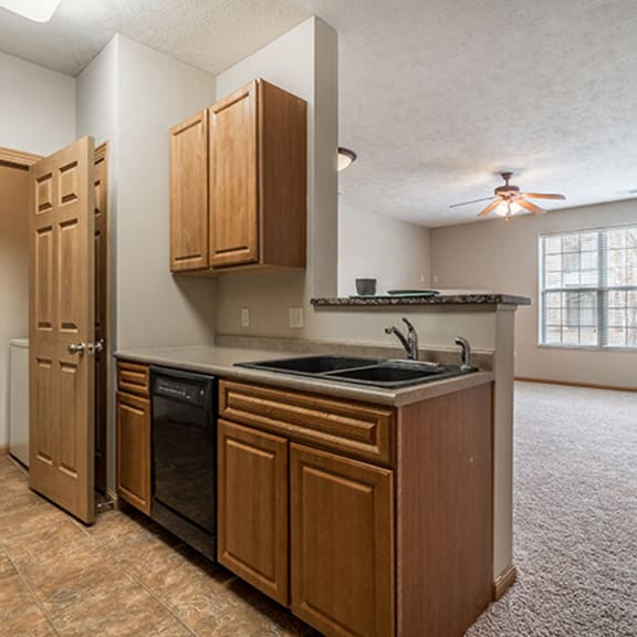 Thumbnail 4 of 9 Kitchen with Washer and Dryer in closet at Stone Creek Villas Apartments in Omaha Nebraska