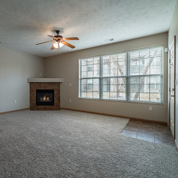 Thumbnail 5 of 9 Spacious Large Living Room with Fireplace and abundant natural light at Stone Creek Villas Apartments in Omaha Nebraska