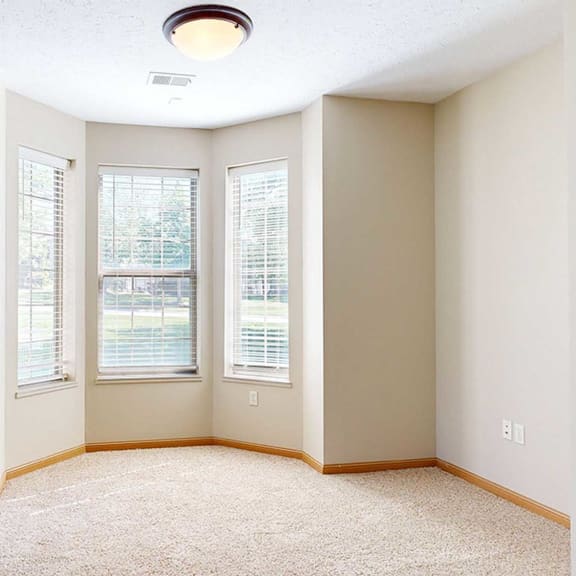 Thumbnail 5 of 28 a living or dining room with three windows and a door