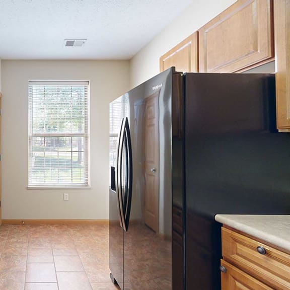Thumbnail 8 of 28 a kitchen with a black refrigerator, a swan stone sink, and a window