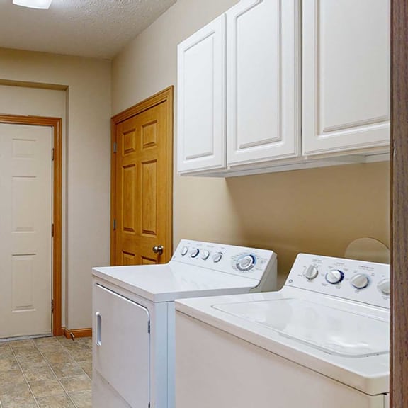 Thumbnail 27 of 28 a laundry room with white appliances and a door to the garage