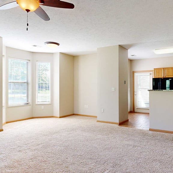 Thumbnail 6 of 28 a living room featuring a windowed dining area adjacent to a kitchen