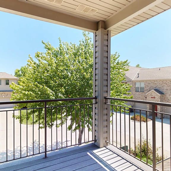 Thumbnail 12 of 24 the view from the corner balcony with a tree that provides privacy