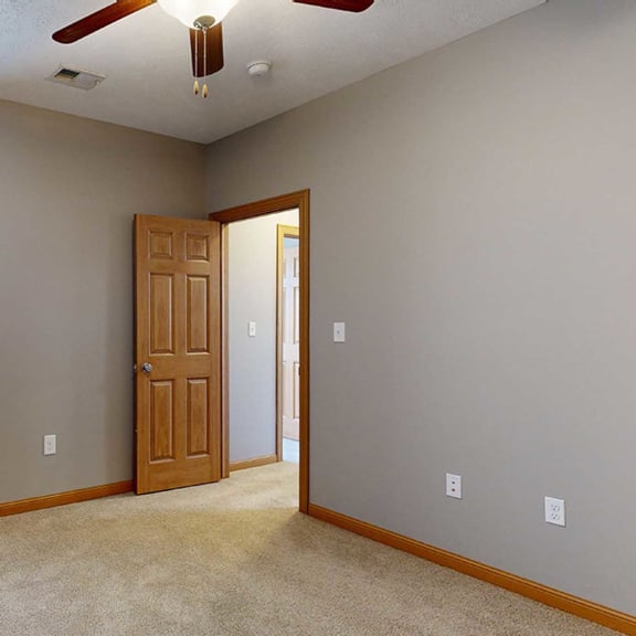 Thumbnail 15 of 24 a bedroom with a tall window and a ceiling fan