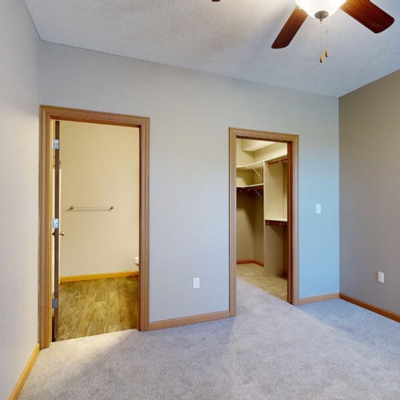 Thumbnail 16 of 24 a bedroom with an attached bathroom and a walk-in closet