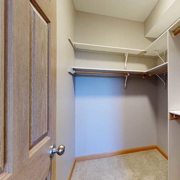 Thumbnail 17 of 24 a walk in closet with built-in shelves and hanging space