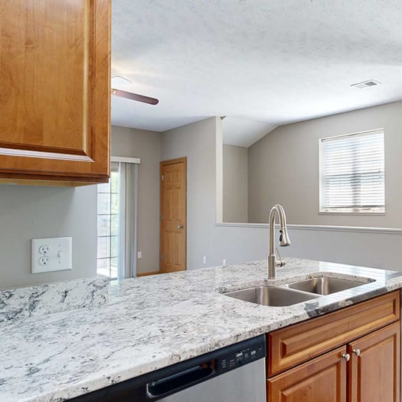 Thumbnail 9 of 24 a kitchen peninsula with a sink with granite counter tops