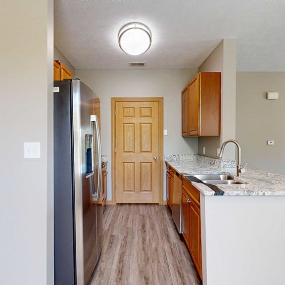 Thumbnail 6 of 24 a galley kitchen with granite counter tops and stainless steel appliances