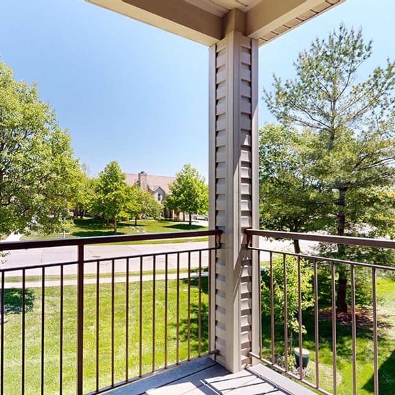 Thumbnail 17 of 32 a balcony with a view of a grassy area below and trees