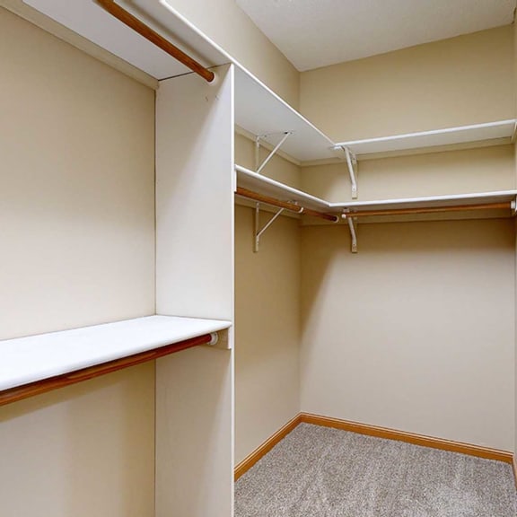 Thumbnail 21 of 32 a walk in closet with built-in shelves