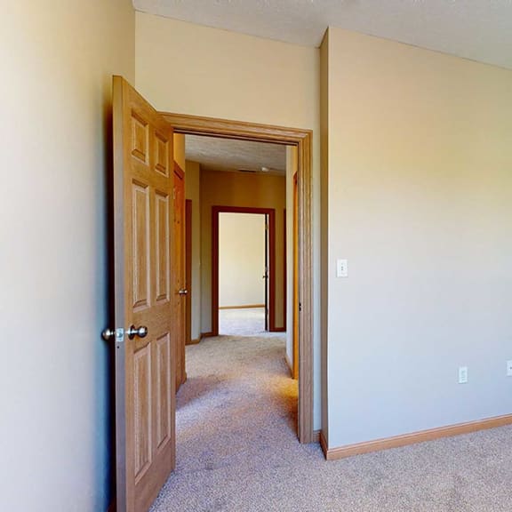 Thumbnail 25 of 32 a bedroom with a door to a hallway