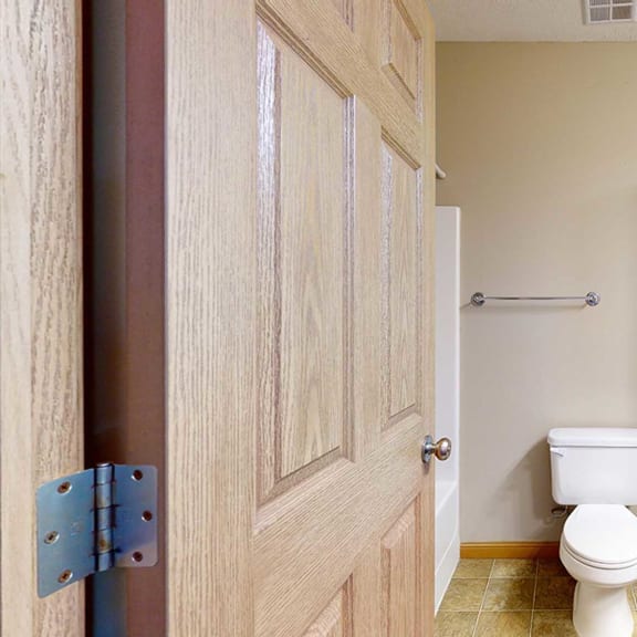 Thumbnail 30 of 32 a bathroom with a toilet, a sink, and tall storage cabinets