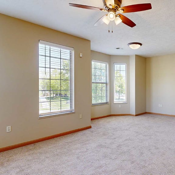 Thumbnail 7 of 32 a living room with a ceiling fan adjacent to a dining space and kitchen
