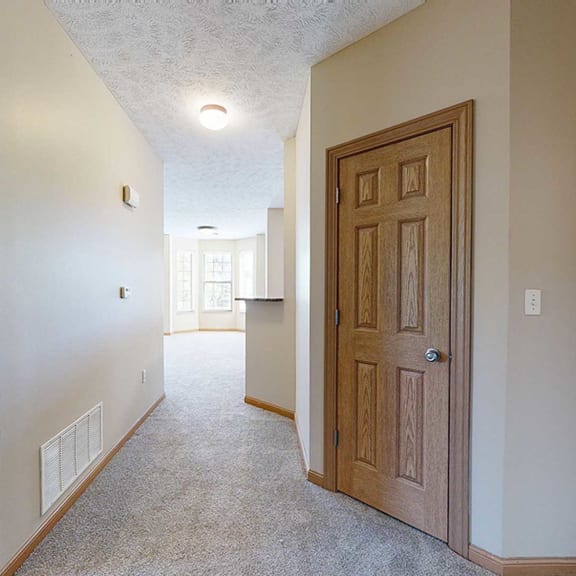 Thumbnail 3 of 32 a hallway with doors to a mechanical closet, coat closet, and primary bedroom