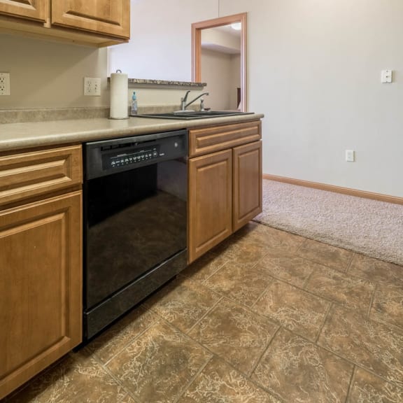 Thumbnail 3 of 12 a kitchen with a dishwasher and a sink