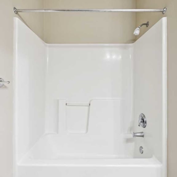 Thumbnail 19 of 23 Tub and shower combination with white surround and chrome fixtures.