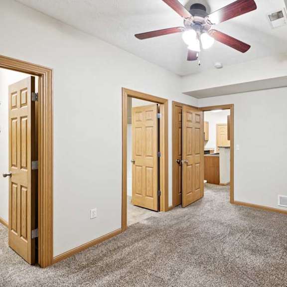 Thumbnail 15 of 23 Bedroom with vaulted ceiling, ceiling fan, and open doorway to en-suite bathroom and closet.