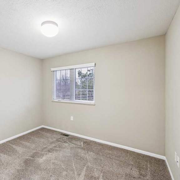 Thumbnail 16 of 26 Secondary bedroom with neutral carpet, ceiling light, and window with blinds.