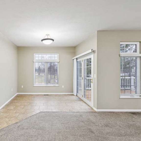 Thumbnail 9 of 26 Dining area with tile flooring, large windows, and sliding glass door to deck.