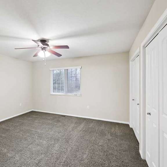 Thumbnail 22 of 25 Bedroom with ceiling fan, double-door closet, and neutral finishes.
