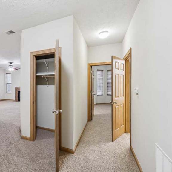 Thumbnail 16 of 21 Interior hallway with closet storage connecting kitchen, living room, and bedroom areas.