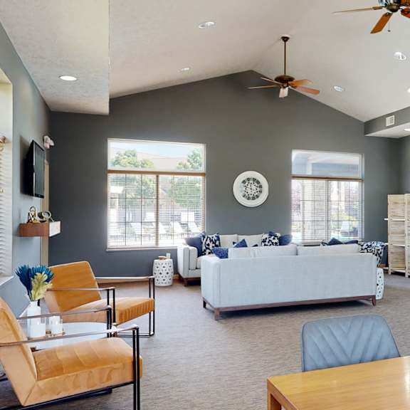 clubhouse living room with gray walls and a stone fireplace