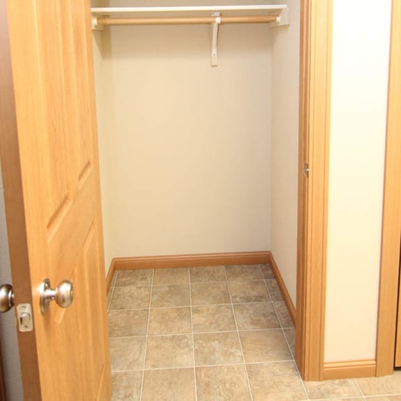 Thumbnail 8 of 12 an empty closet in a bathroom with a door