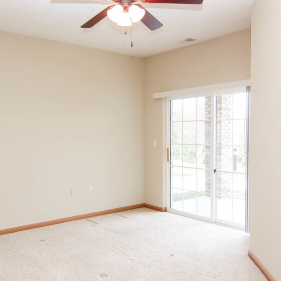 Thumbnail 11 of 12 an empty living room with a ceiling fan