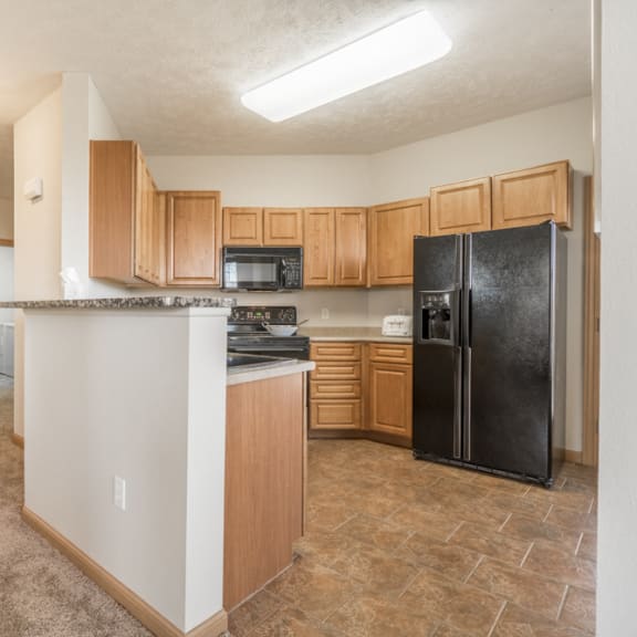 Thumbnail 6 of 12 Large kitchen with side-by-side fridge at Stone Ridge Estates townhomes in south Lincoln NE