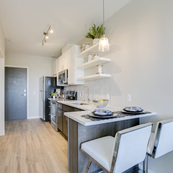 Thumbnail 9 of 11 Studio kitchen with breakfast bar at The Central apartments near downtown Minneapolis MN 55408