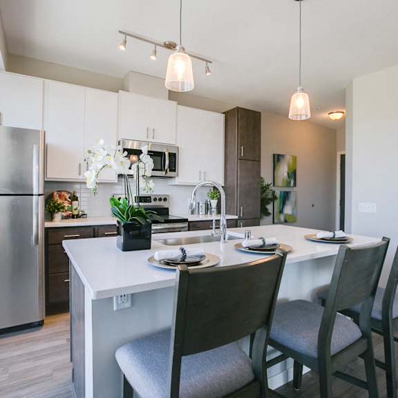 Thumbnail 6 of 15 Kitchen with island and pendant lighting at The Central apartments near downtown Minneapolis MN 55408