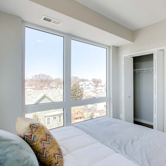 Thumbnail 13 of 15 Bedroom with large windows at The Central apartments near downtown Minneapolis MN 55408