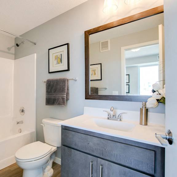 Thumbnail 15 of 15 Bathroom with tub and quartz countertops at The Central apartments near downtown Minneapolis MN 55408