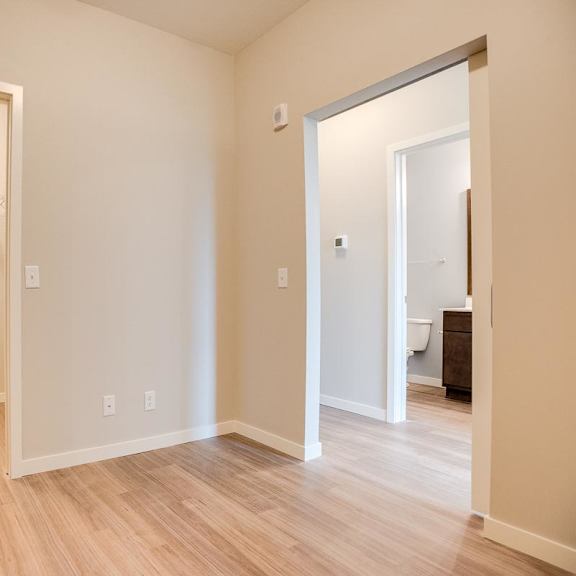 Thumbnail 6 of 6 A room with doors to a walk-in closet and hallway