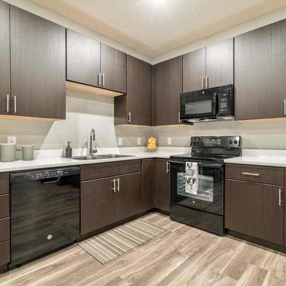 Thumbnail 3 of 11 Traditional design kitchen with dark cabinetry, quartz countertops in Blackstone District Omaha