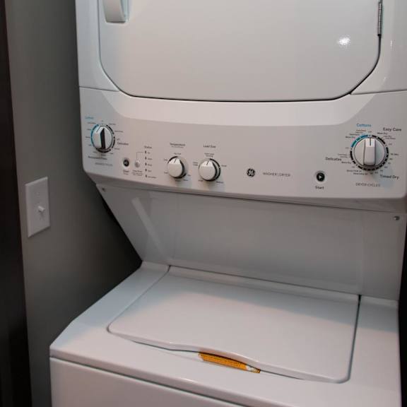 Thumbnail 6 of 6 Stacked washer and dryer in closet next to extra storage closet