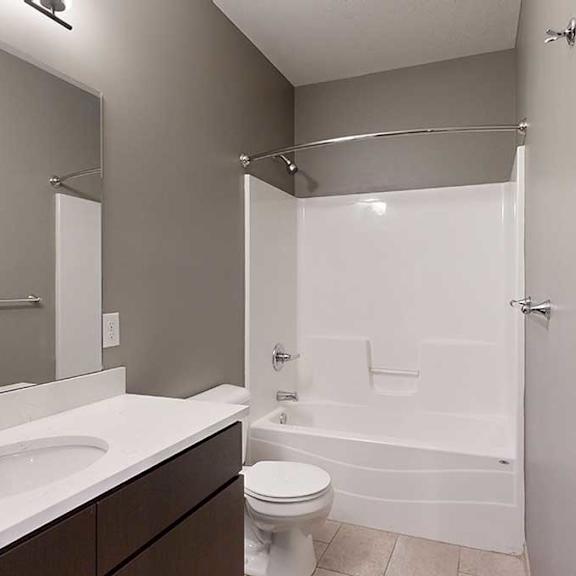Thumbnail 20 of 21 a bathroom with a white granite vanity sink,  and a combo bathtub and shower