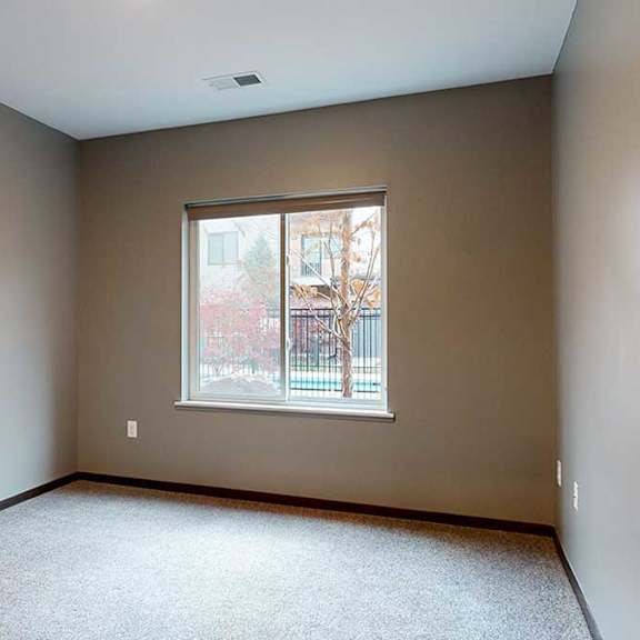 Thumbnail 17 of 21 a bedroom with a window with a granite windowsill overlooking a tree-lined courtyard