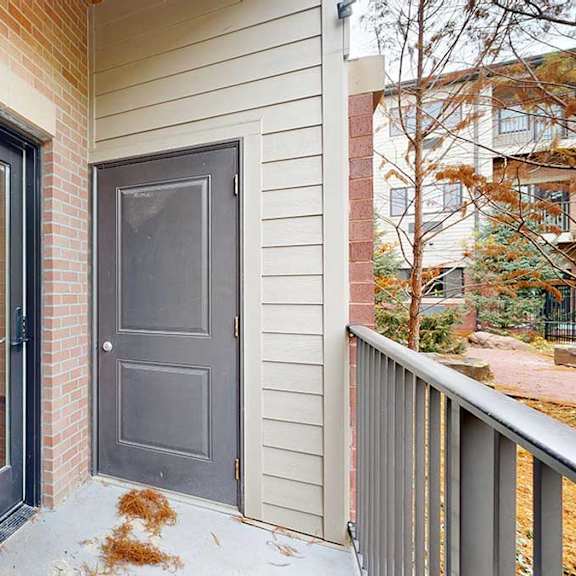 Thumbnail 10 of 21 a patio with a door to an outdoor storage closet and a glass door and a window looking from the living room