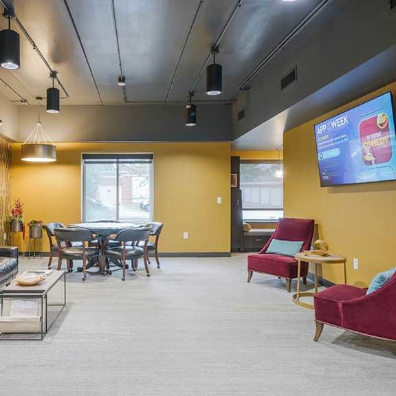 a spacious lounge/pub room with couch and table seating and a tv