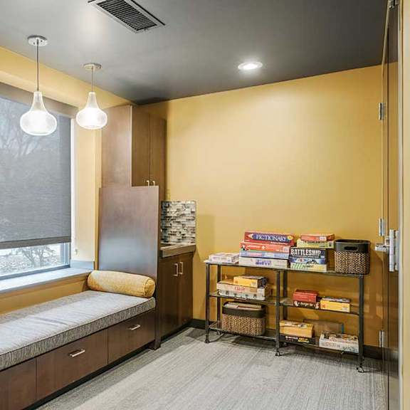 a pub room with built-in lounge/bench seating with board games